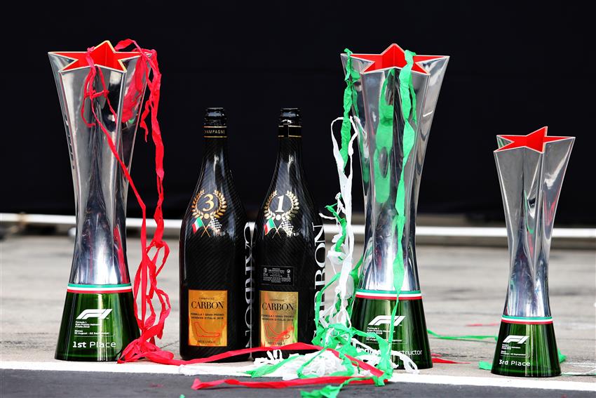 Three trophies and two bottles of champagne