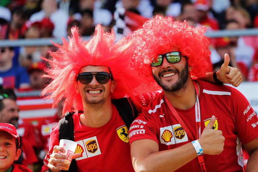 Two fans with red wigs